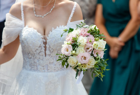 A bouquet of flowers in the hands of the bride.