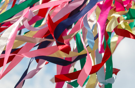 Multicolored festival ribbons flutter in the wind. Background.の写真素材