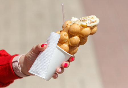 Close up of waffle ice cream in hand.の写真素材