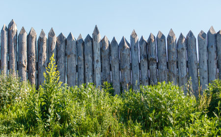 Wooden log fence against the sky.の写真素材
