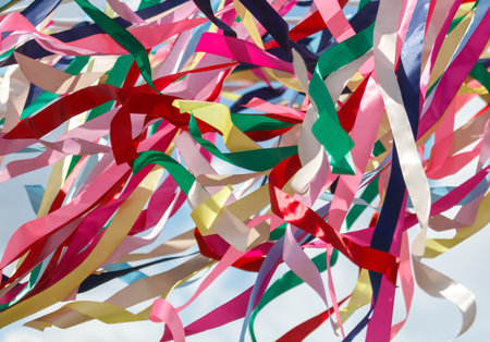 Multicolored festival ribbons flutter in the wind. Background.の写真素材