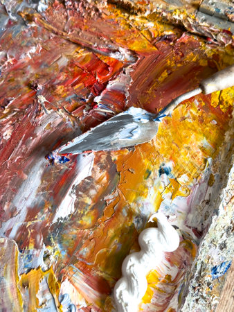 Close-up of a spatula in artist's paints.の写真素材