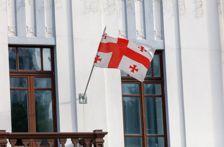 The Georgian flag hangs on the wall of the building.の写真素材