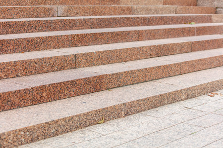 A staircase made of stone with a leaf on it. The staircase is very tall and has many stepsの写真素材