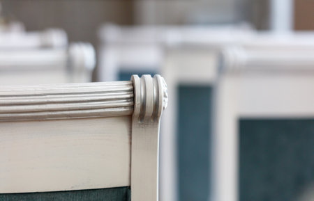 A row of chairs with a white back and blue trim. The chairs are all lined up and appear to be empty