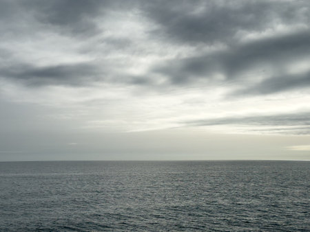 A cloudy sky with a large body of water in the backgroundの写真素材