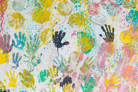 A colorful painting of many hands with different colors. The painting is full of life and energy. It...