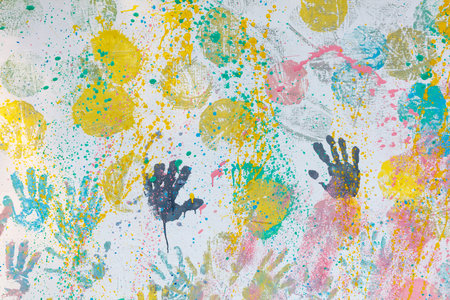 A colorful painting of many hands with different colors. The painting is full of life and energy. It seems to be a representation of the diversity and uniqueness of each individualの写真素材