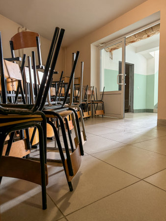 A room full of chairs with a door in the background. The chairs are all empty