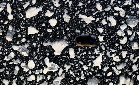 Dirt on the body of a black surface. Abstract background.