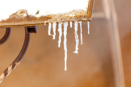 A table covered in ice and snow. The ice is dripping from the top of the table. Scene is cold and wintryの写真素材