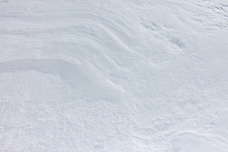 A snow covered ground with a white line in the middle. The line is a waveの写真素材