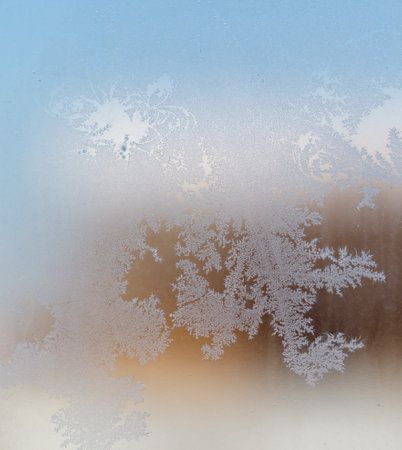 Frost patterns on window glass. Cold winter background.の写真素材