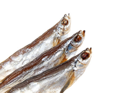 Three fish are shown on a white background. The fish are all different sizes and are all facing the same directionの写真素材