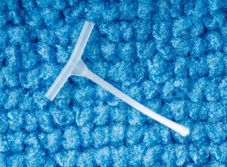 A small plastic object is on a blue carpet. The carpet is blue and has a fuzzy textureの写真素材