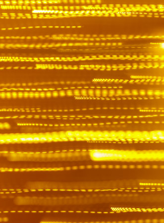 A yellow background with many lines and dots. The background is blurry and the lines are thinの写真素材