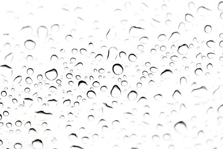 The image is of raindrops on a window. The drops are small and scattered, creating a sense of...