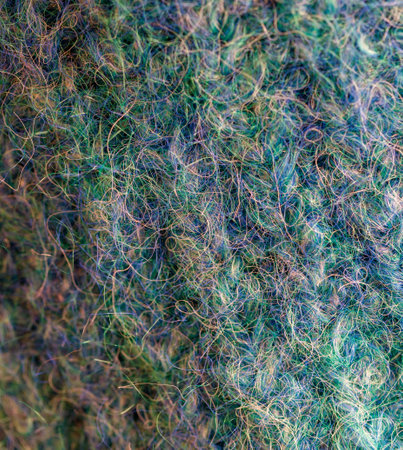 The image is of a fuzzy, green and blue texture. The texture is made up of many different shades of...