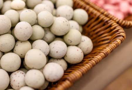 A basket full of white balls. The basket is made of wicker