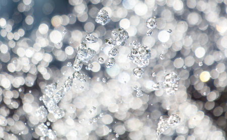 The image is of a spray of water with many small, sparkling droplets. The water droplets are scattered throughout the image, creating a sense of movement and energy. Scene is one of funの写真素材