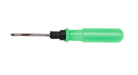 A green screwdriver with a black handle. The screwdriver is on a white background. The screwdriver is old and rustyの写真素材