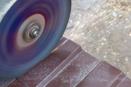 A grinding wheel is spinning and creating sparks. Concept of action and energy, as the wheel is...
