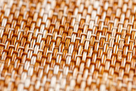 A close up of a woven fabric with brown and white stripes. The texture of the fabric is rough and the colors are warm and invitingの写真素材