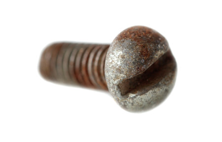 A rusted screw with a missing head. The screw is bent and twisted. The screw is old and wornの写真素材