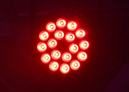 A cluster of red lights are lit up in a circle. The lights are bright and colorful, creating a...