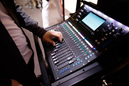 A person is playing a keyboard with a large number of buttons. The person is wearing a black jacket...