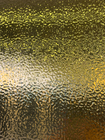 A gold colored surface with a lot of texture. The surface is shiny and reflective. The texture of the surface is very intricate and detailedの写真素材