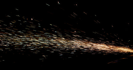 A black and white photo of a firework display with a lot of sparks. Scene is energetic and exciting, as the fireworks are in motion and the sparks are flying in all directionsの写真素材