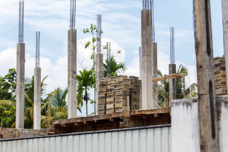 A construction site with a lot of scaffolding and a large pile of bricks. Scene is one of hard work and progressの写真素材