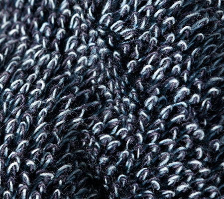 A close up of a blue and white knit sweater. The sweater is made of wool and has a fuzzy texture. The blue and white colors give the sweater a cozy and warm appearanceの写真素材