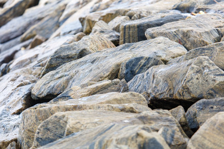 A pile of rocks with a grayish color. The rocks are piled up and have a rough texture
