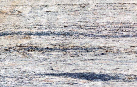The image is of a rock with a blue and white pattern. The rock appears to be old and worn, with a rough texture. The blue and white colors create a sense of calmness and serenityの写真素材