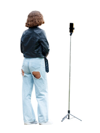 A woman in a leather jacket stands in front of a tripodの写真素材