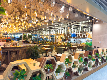 A restaurant with a lot of light fixtures and a lot of plants. Scene is warm and invitingの写真素材