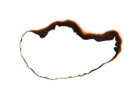 A burnt out spot on a white background. The burnt spot is a dark brown color and it is surrounded by a white backgroundの写真素材
