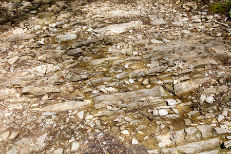 A rocky, barren landscape with a few small rocks scattered around. The image has a desolate and rugged feel to itの写真素材