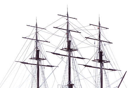A large ship with three masts and a tall mast. The ship is white and the sails are blackの写真素材