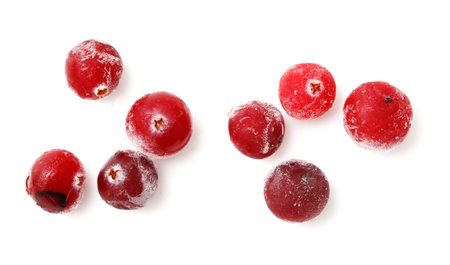 A close up of a bunch of frozen red berries. The berries are frozen and covered in a layer of iceの写真素材