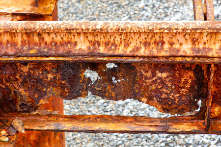 The rusty metal is old and worn, with a lot of rust and holes. It looks like it has been exposed to the elements for a long timeの写真素材