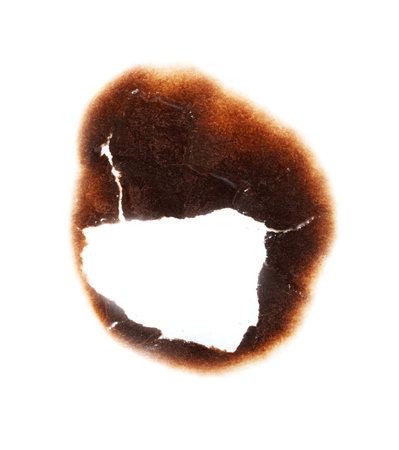 A burnt out spot on a white background. The burnt spot is in the shape of a heartの写真素材