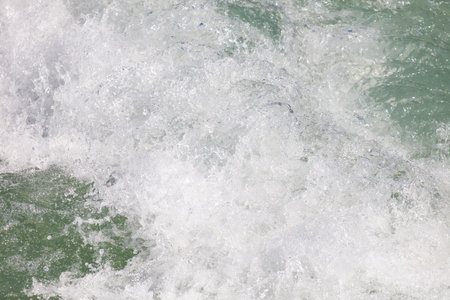 The water is green and white. The water is moving and splashing. The water is calm and peacefulの写真素材