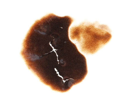 A burnt spot on a white background. The burnt spot is brown and has a rough texture. It is a stain or a mark left behind by something that was once thereの写真素材
