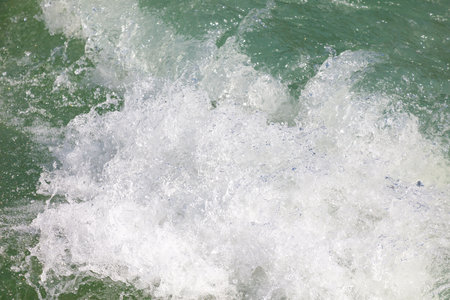 The water is green and white. The water is moving and splashing. The water is calm and peacefulの写真素材
