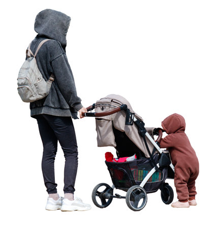 A woman is pushing a stroller with a child in it. The child is wearing a brown coatの写真素材