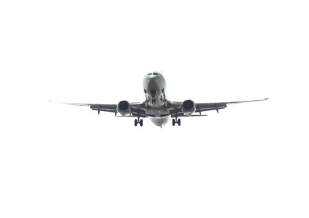 A large jet plane is flying through the sky. The plane is white and has a black nose. The sky is...