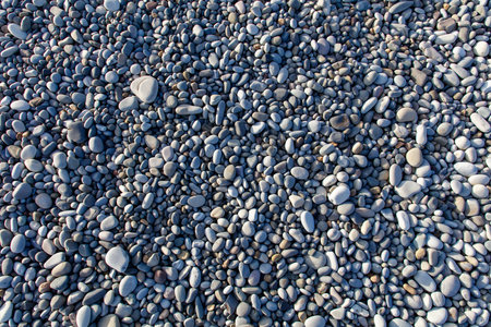 A pile of rocks with a lot of different sizes. The rocks are scattered all over the groundの写真素材